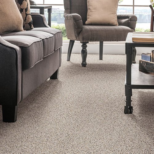Living room with grey sofa and grey carpet from Prestige Flooring Center in Cathedral City, CA